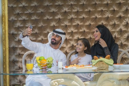 Middle eastern family taking a photo together|-