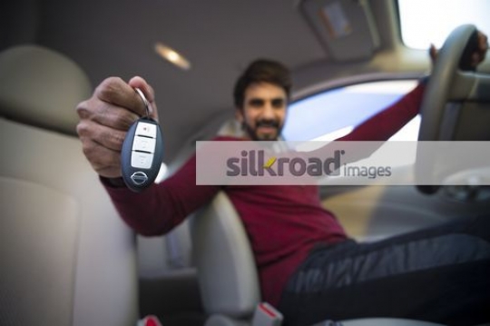 Expat showing the key to the car|