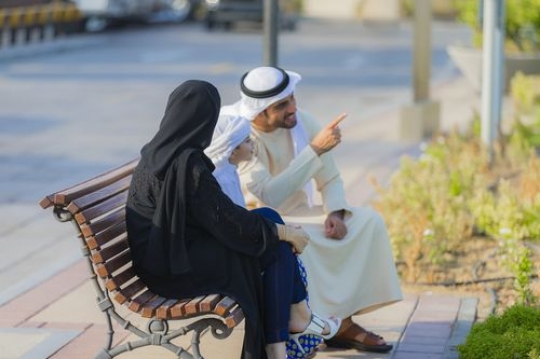 Father is pointing at something and spending time with the family|-