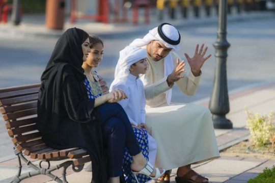 Arab Family dressed in traditional wear and spending time with each other|-