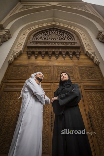Middle Eastern Businessman and Businesswoman standing with their arms crossed