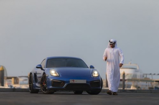 Middle eastern man in motion while walking away from his vehicle|-