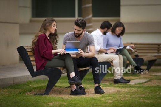 Students sitting on the bench together|-