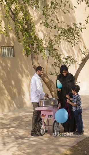 Arab mother got cotton candy for her young boy|-