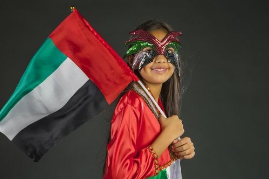 Girl carrying the UAE flag
