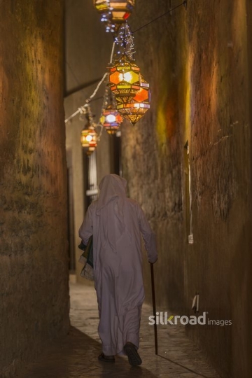 Arab man walking through the pathway of the Ramadan Lanterns|-