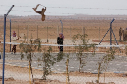 tennis ground behind a fence
