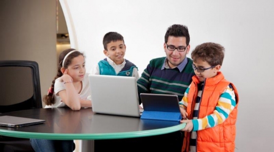 Kids and Teachers at Computer Class
