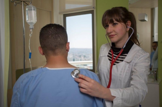 A Woman Doctor Examining Patient at Hospital