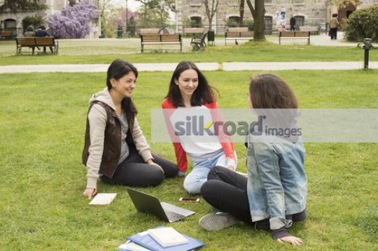 Three women sitting together talking|