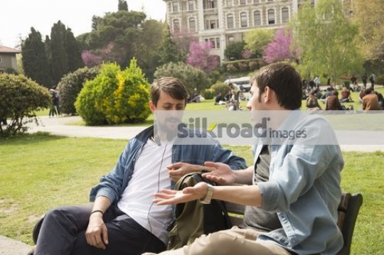 Two friends sitting together chatting