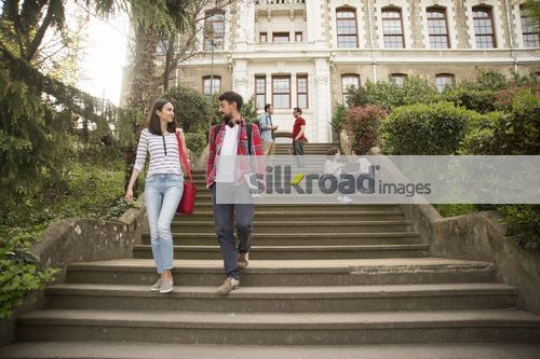 European Man and Woman walking down the stairs|