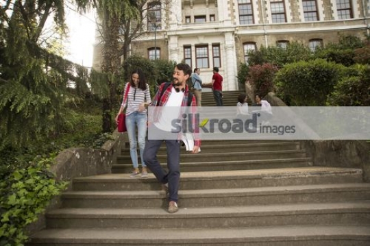 University students walking down the stairs together|
