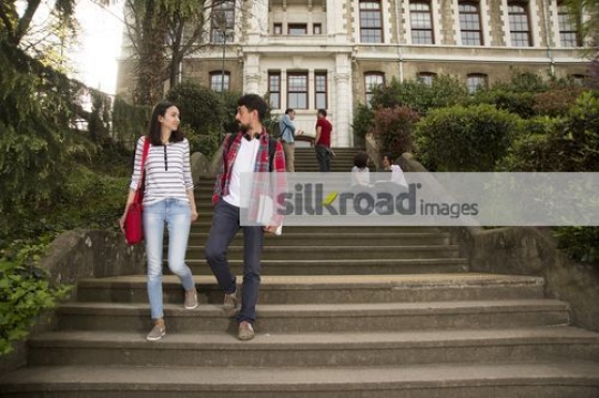University students walking together down the stairs|