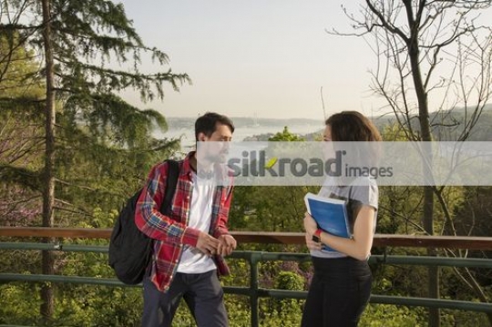 Man and Woman standing talking to each other|