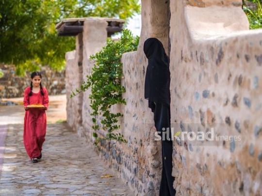 Girl carrying plate and walking towards woman|-