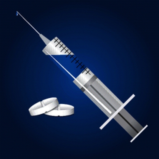 syringe and pills against blue