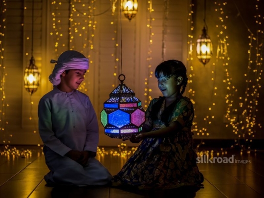 brother and sister playing with lantern|-