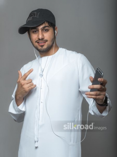 Young arab boy dressed in the traditional attire wearing a hat 