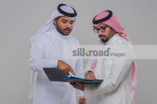 Arab men talking to each other about work|