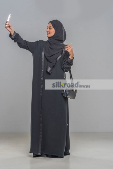 Middle Eastern woman taking a selfie herself