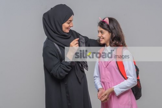 Middle Eastern woman talking to the young kid
