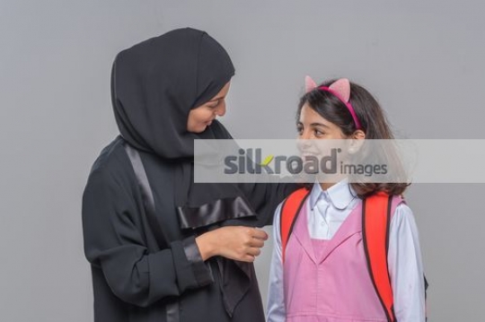 Arab woman talking to the young kid|
