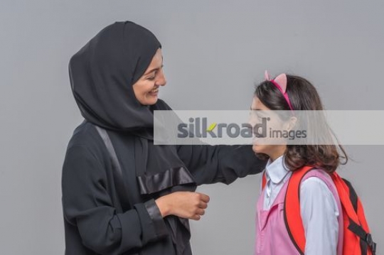Middle Eastern woman talking to the young kid|