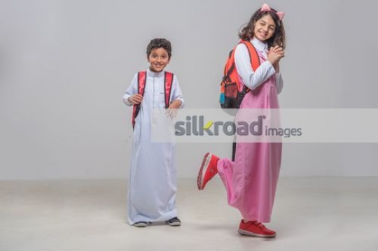 Middle Eastern kids carrying the school bags