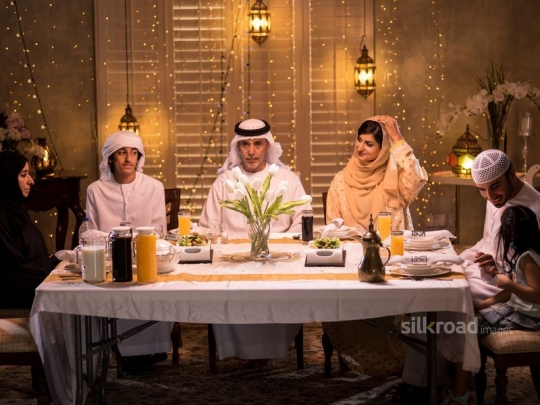 Family around dining table|-