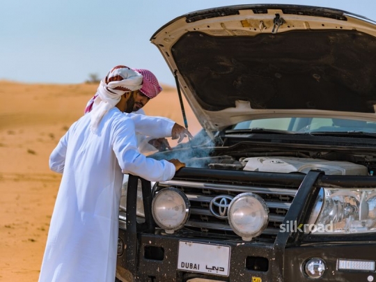 Friends fixing broken car