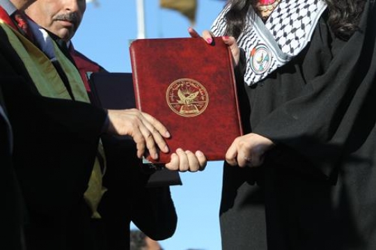 palestinian girl holding a certificate