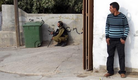 Man hiding behind wall