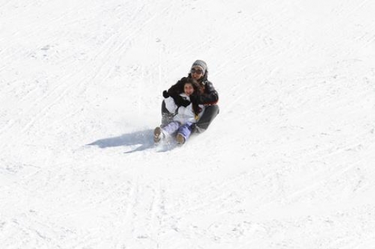 Woman and child playing in snow