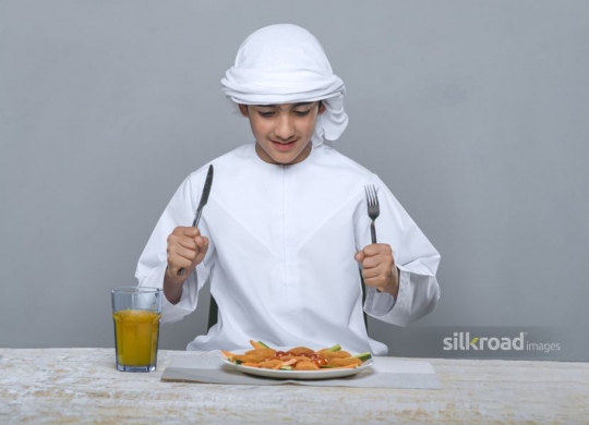 Arabian boy impatient to eat