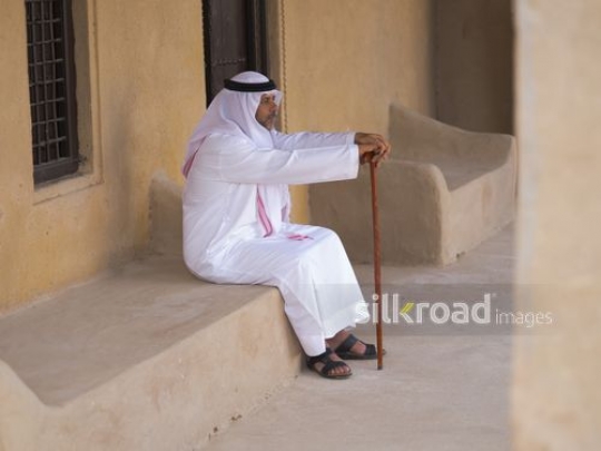 Old man sitting outside|-