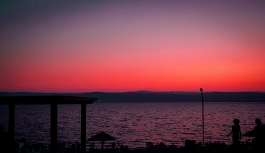 people by the beach on sunset