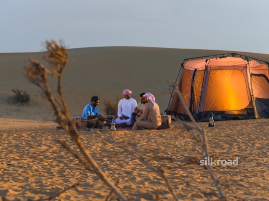 Friends playing cards during magical hours