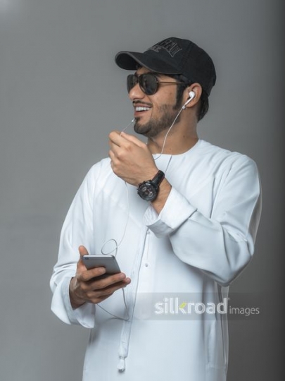 Funky young man speaking through microphone