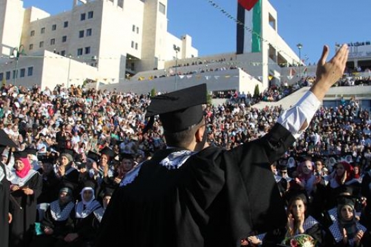 young graduate student waving his hand