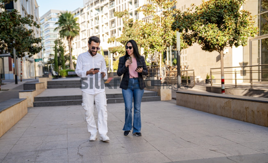 Professional Man and Woman Smiling with Coffee in Al Abdali Boulevard