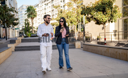 Professional Man and Woman Smiling with Coffee in Al Abdali Boulevard