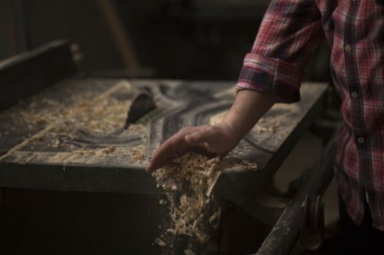 Worker removing the dust off the table