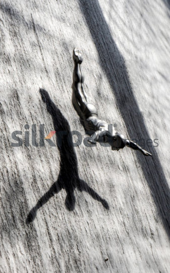 Silver Diver Sculpture in Mid-Dive with Shadow on Waterfall