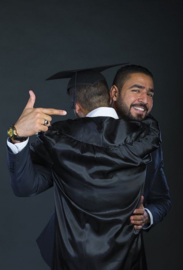 A proud dad greeting his son