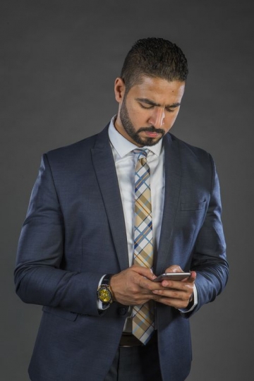 An Arab Businessman Texting on Mobile|-