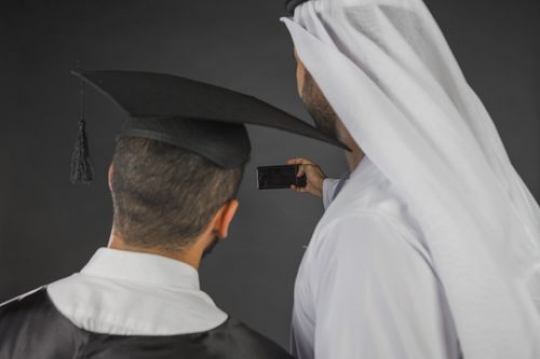 Middle Eastern father and son taking a picture together