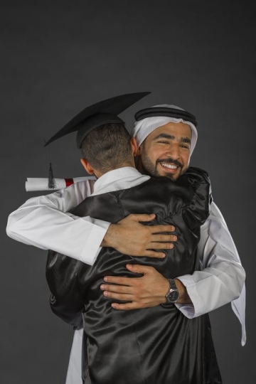 A Middle Eastern father hugging his son