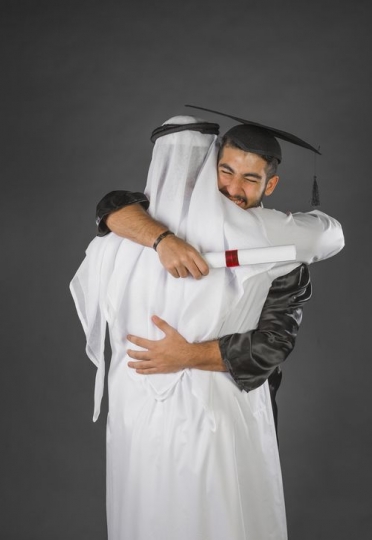 Middle Eastern man congratulating his son|-