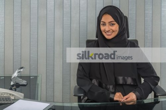Middle eastern woman sitting at the office desk|